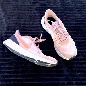 Nike revolution sneakers rose gold mauve pink color and black on the heels.